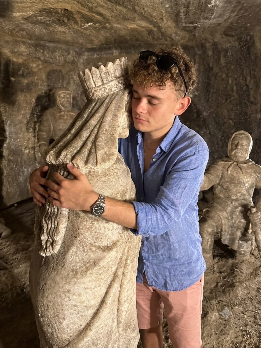 A visitor climbing on and hugging a protected object.